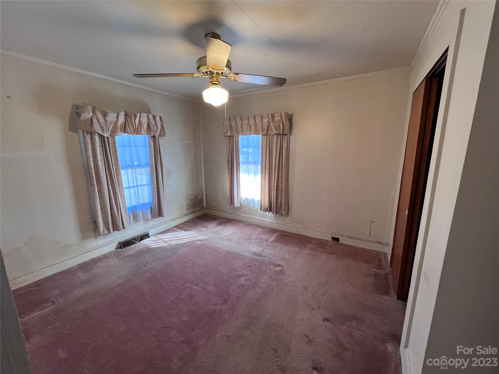 127 River Loop Road Belmont, NC 28012 - Photo 18 of 34 an empty room with windows and a chandelier fan