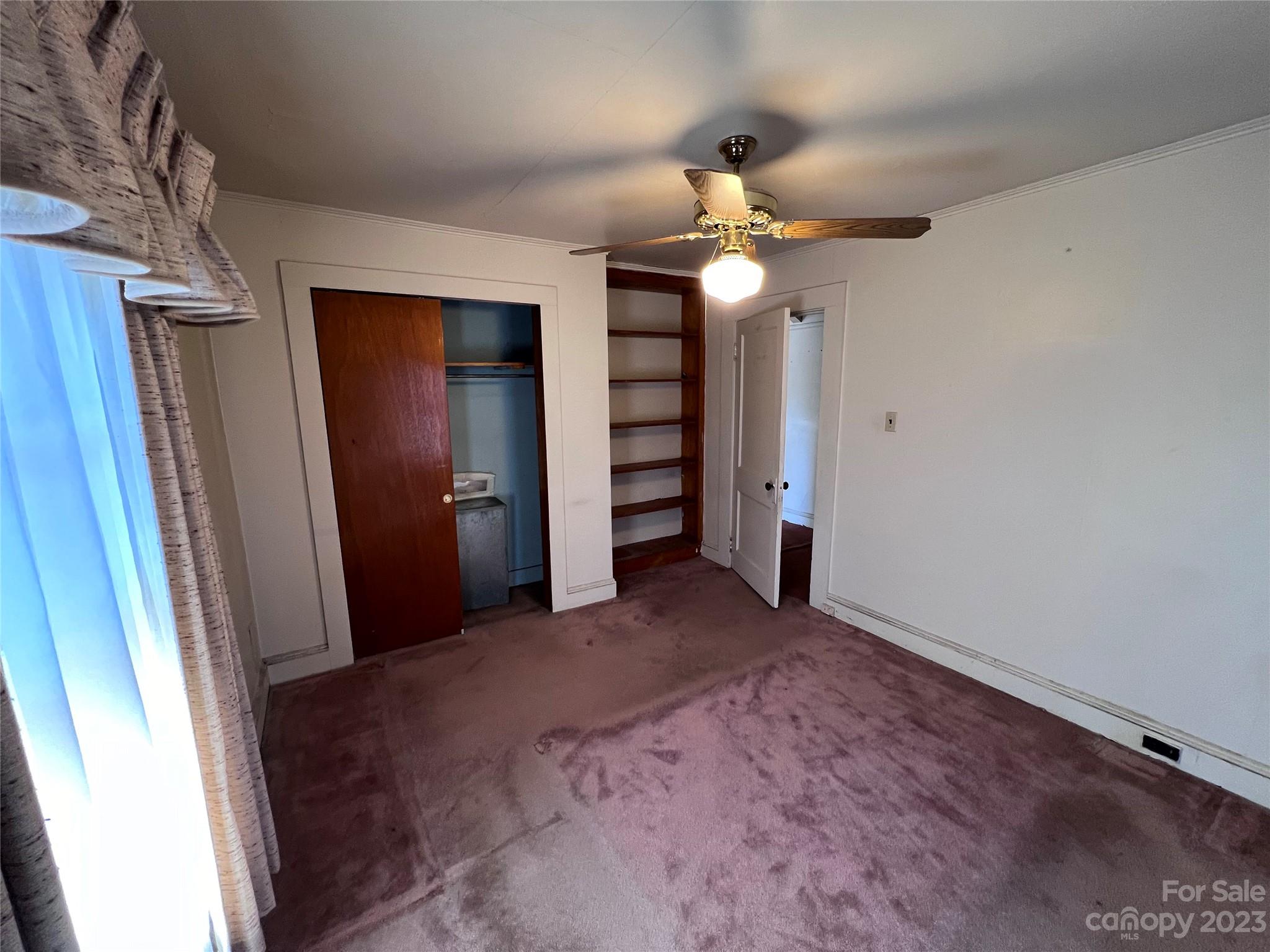 127 River Loop Road Belmont, NC 28012 - Photo 19 of 34 an empty room with closet and a chandelier fan