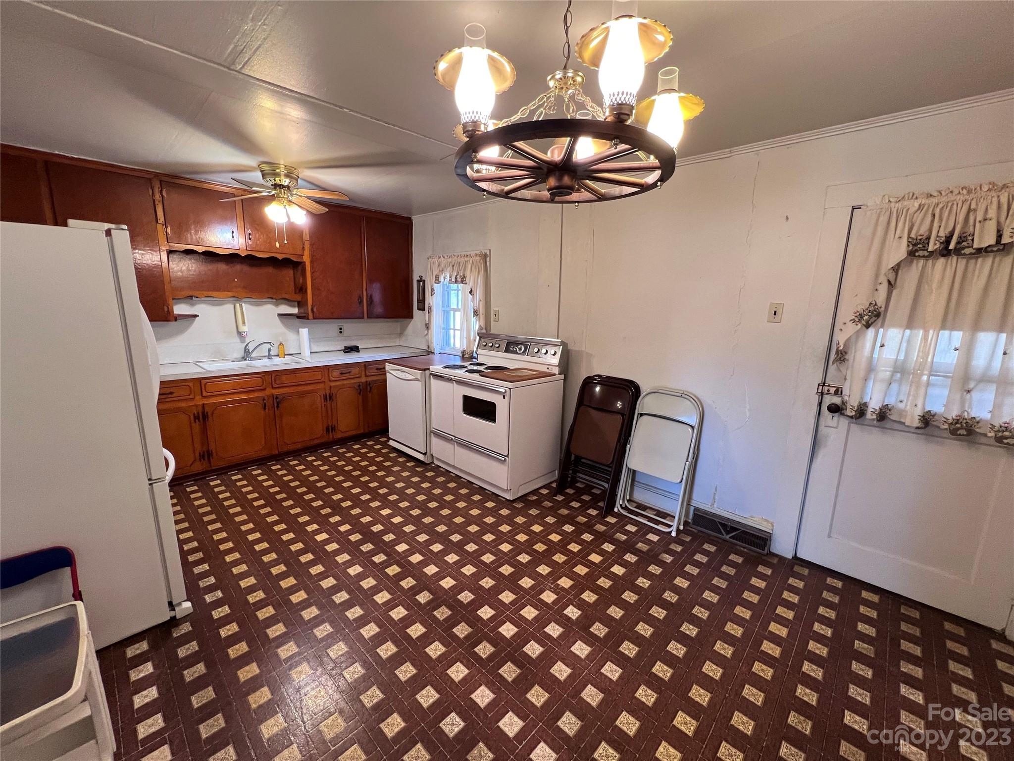 127 River Loop Road Belmont, NC 28012 - Photo 24 of 34 a kitchen with a sink a stove a dining table and chairs
