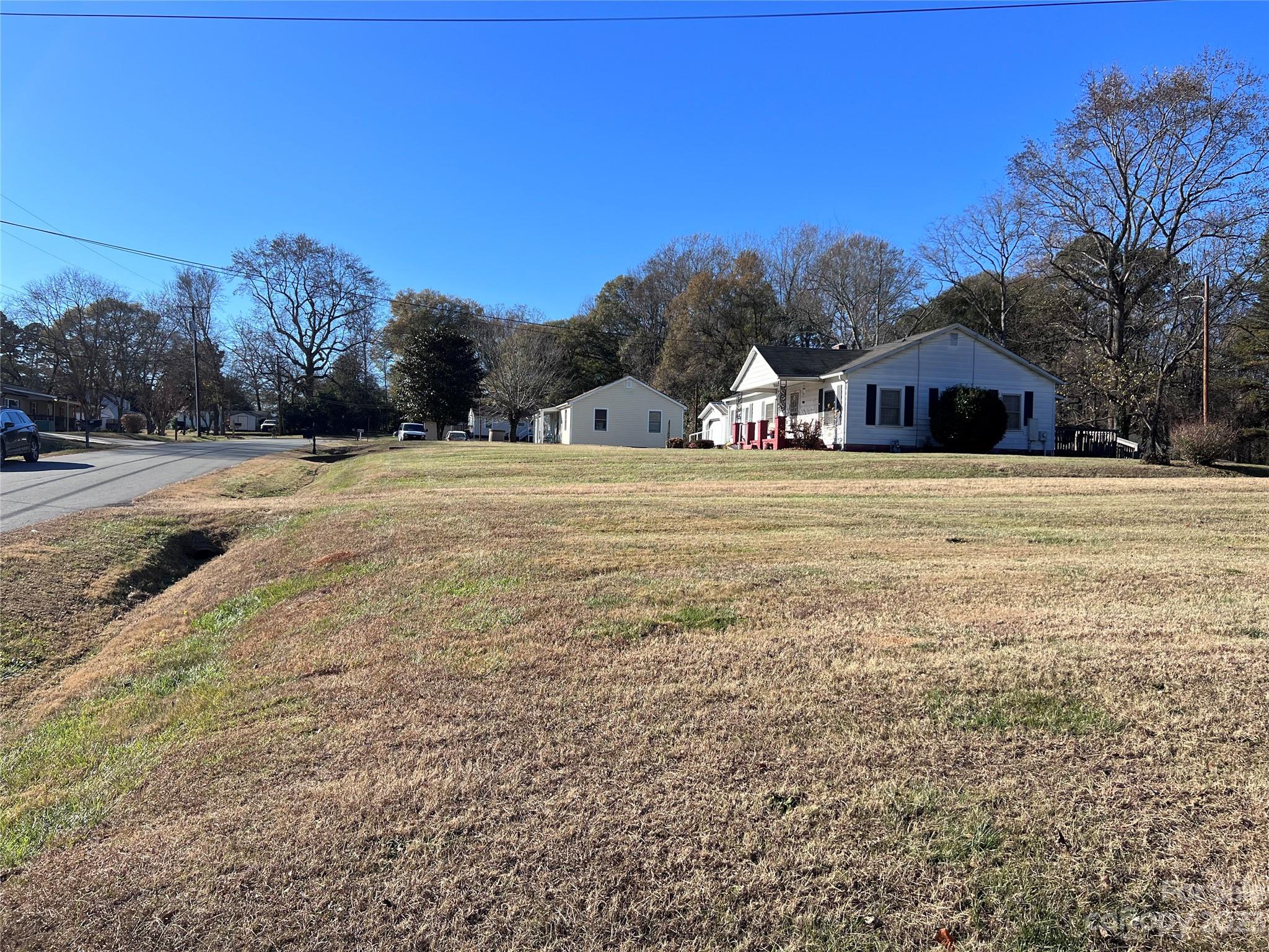127 River Loop Road Belmont, NC 28012 - Photo 3 of 34 a front view of a house with a yard and trees