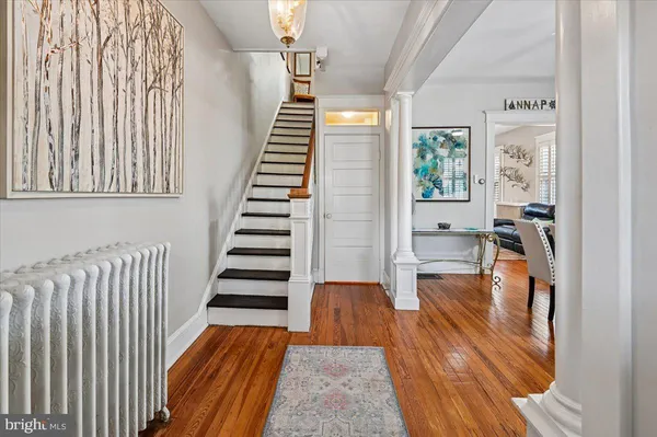 a living room with fireplace furniture and a wooden floor