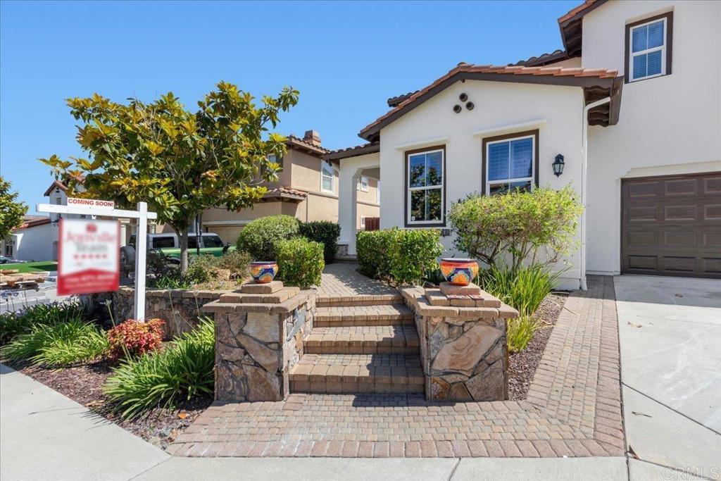 838 Luminara Way San Marcos, CA 92078 - Photo 14 of 54 a front view of a house with garden