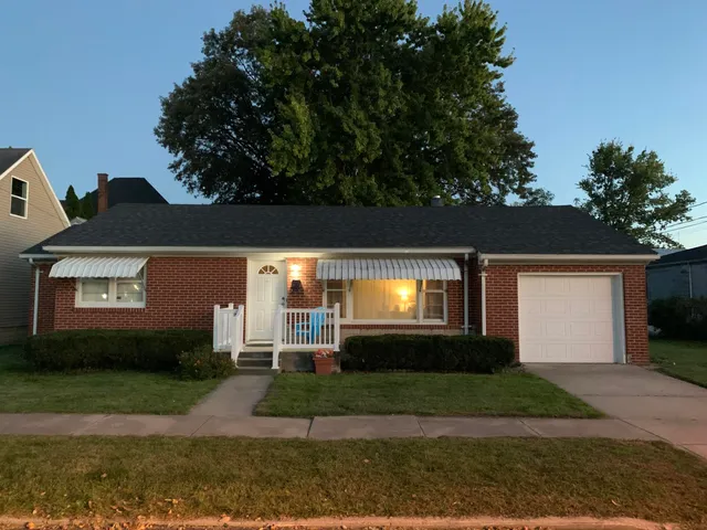 a view of a front door and a yard