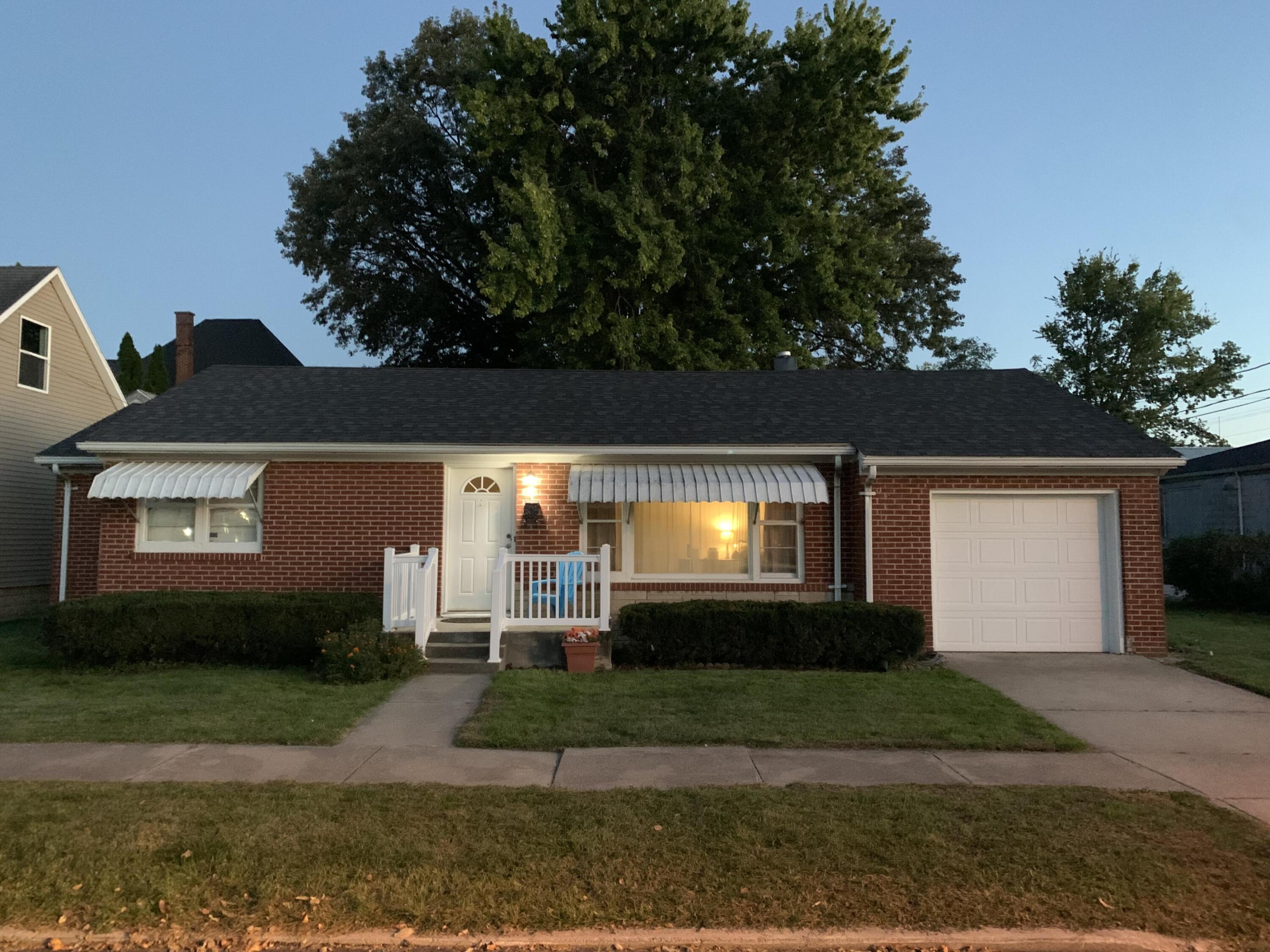a view of a front door and a yard