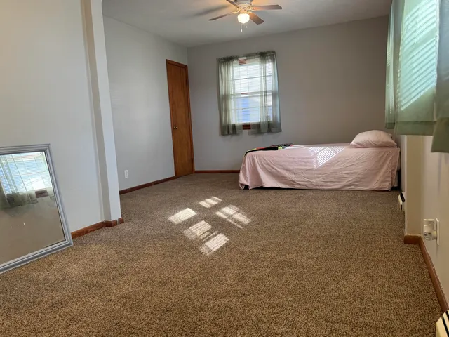 a bedroom with a bed and window