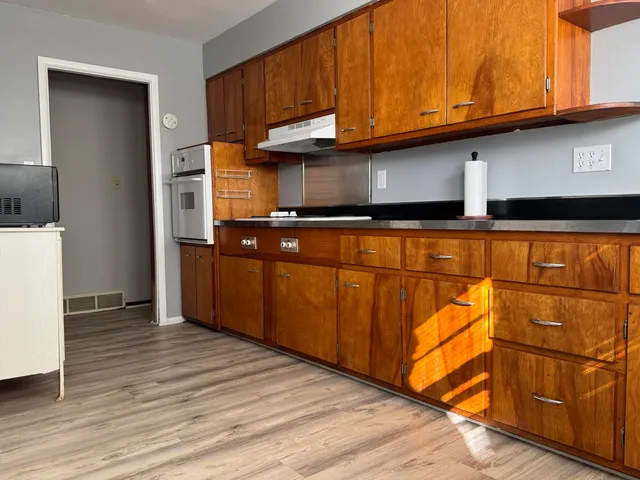 a kitchen with stainless steel appliances granite countertop a refrigerator