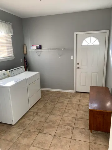 a bedroom with a bed and a chair