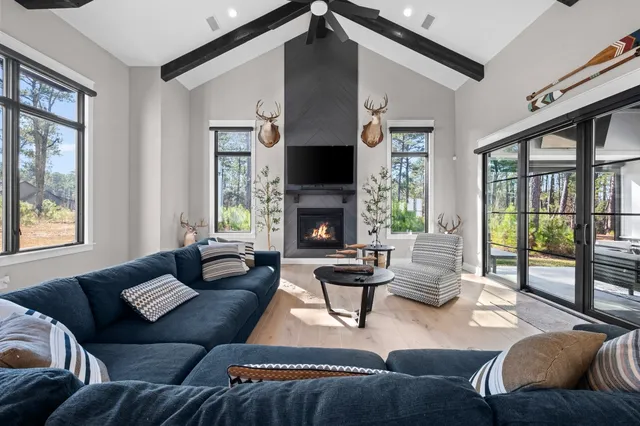 a living room with furniture fireplace and a large window