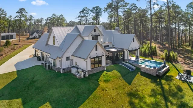 an aerial view of a house with swimming pool table and chairs