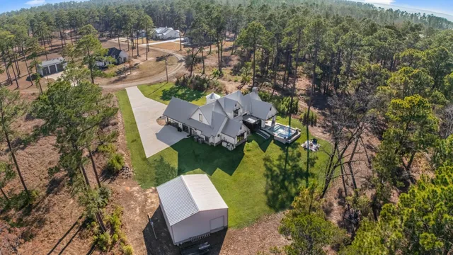 an aerial view of a house with a yard basket ball court and outdoor seating