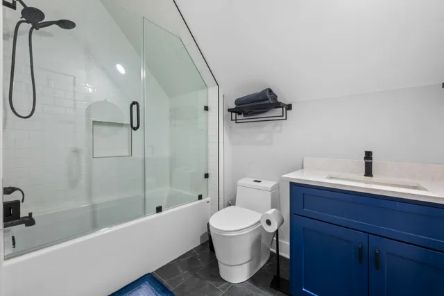 a bathroom with a toilet sink and shower
