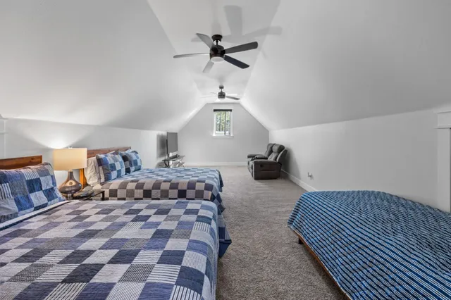 a bedroom with a bed and a lamp on the dresser