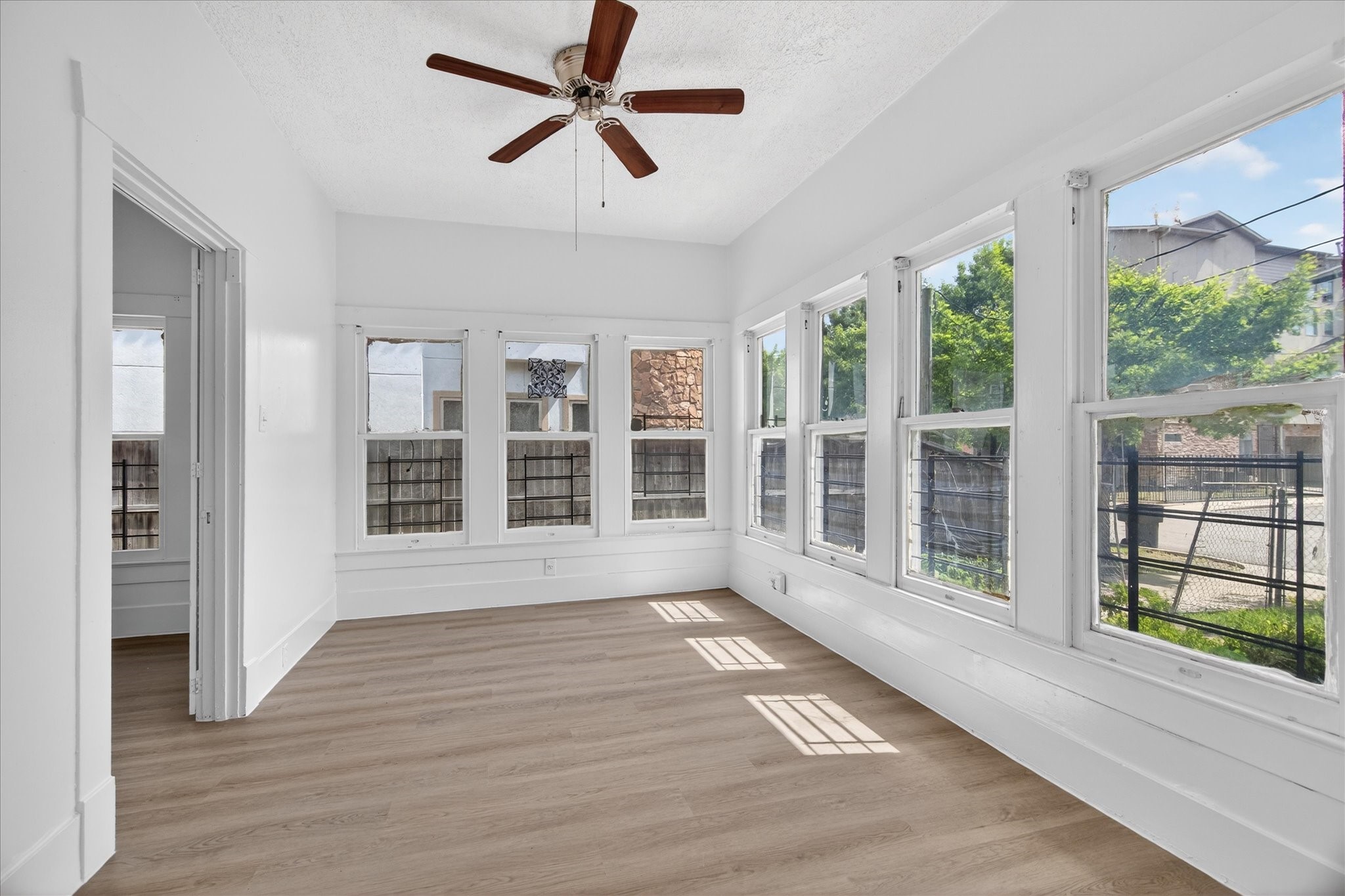 1607 Holman Street Houston, TX 77004 - Photo 13 of 24 a view of an empty room with a window and wooden floor