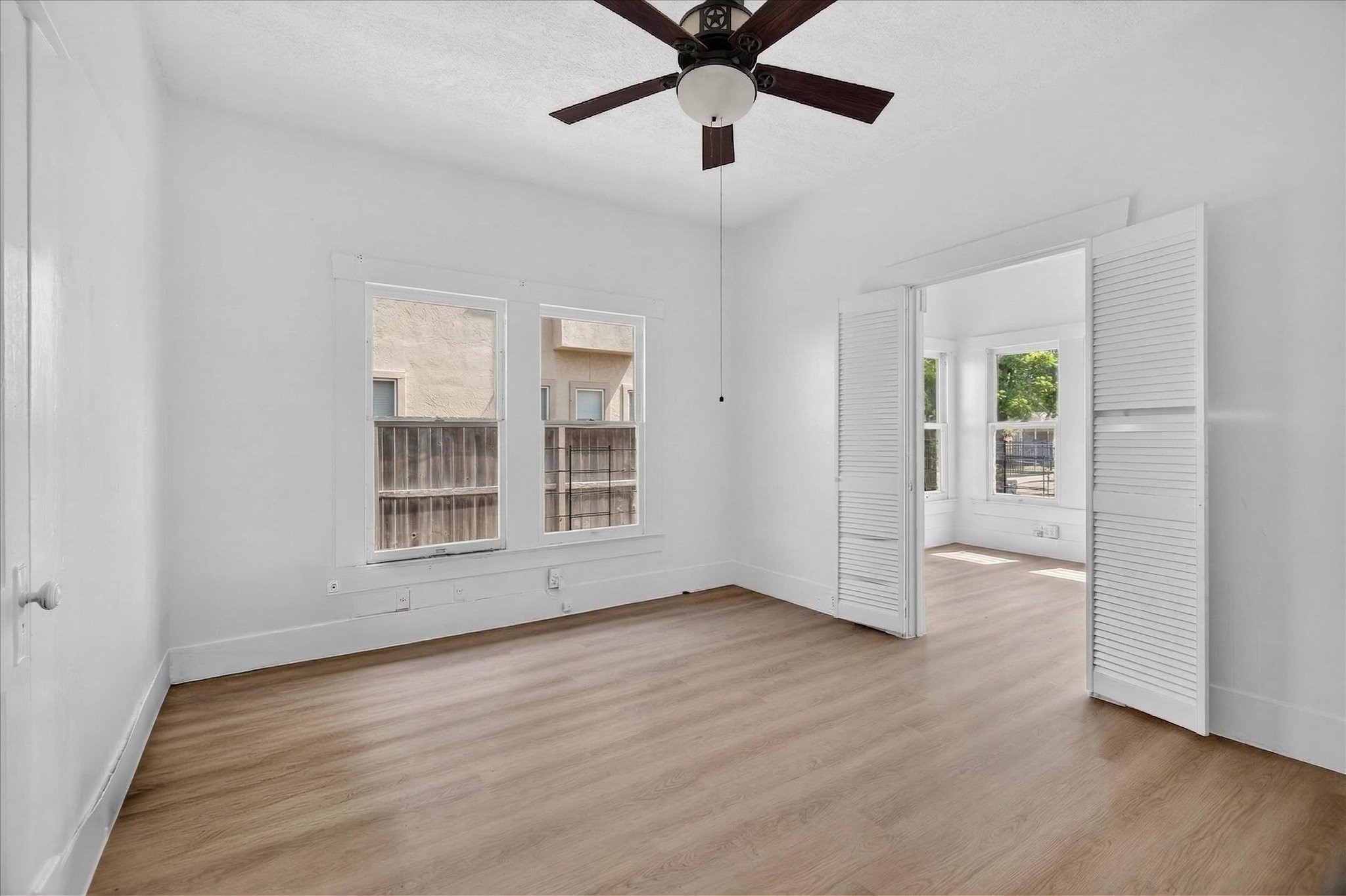 1607 Holman Street Houston, TX 77004 - Photo 16 of 24 a view of an empty room with wooden floor and a window