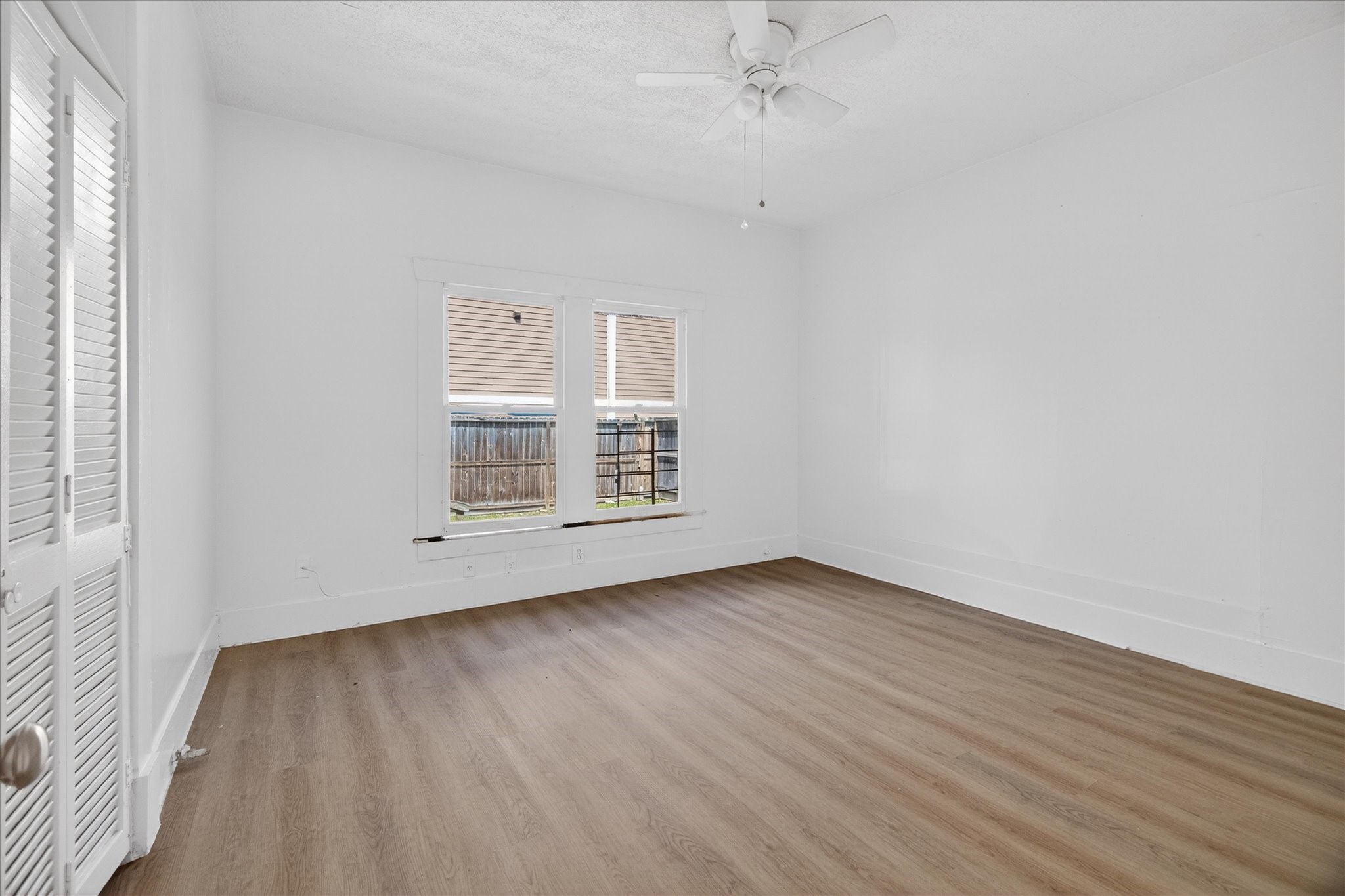 1607 Holman Street Houston, TX 77004 - Photo 18 of 24 a view of an empty room with wooden floor and a window
