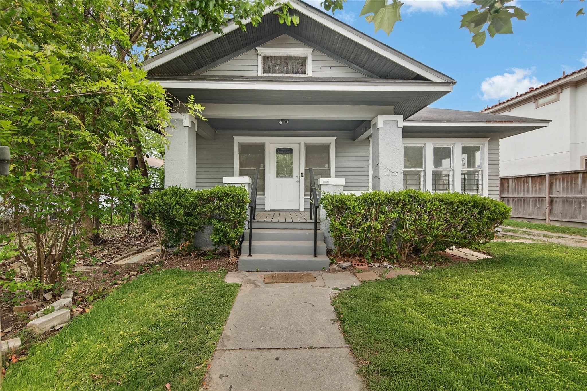 1607 Holman Street Houston, TX 77004 - Photo 2 of 24 a front view of a house with a yard
