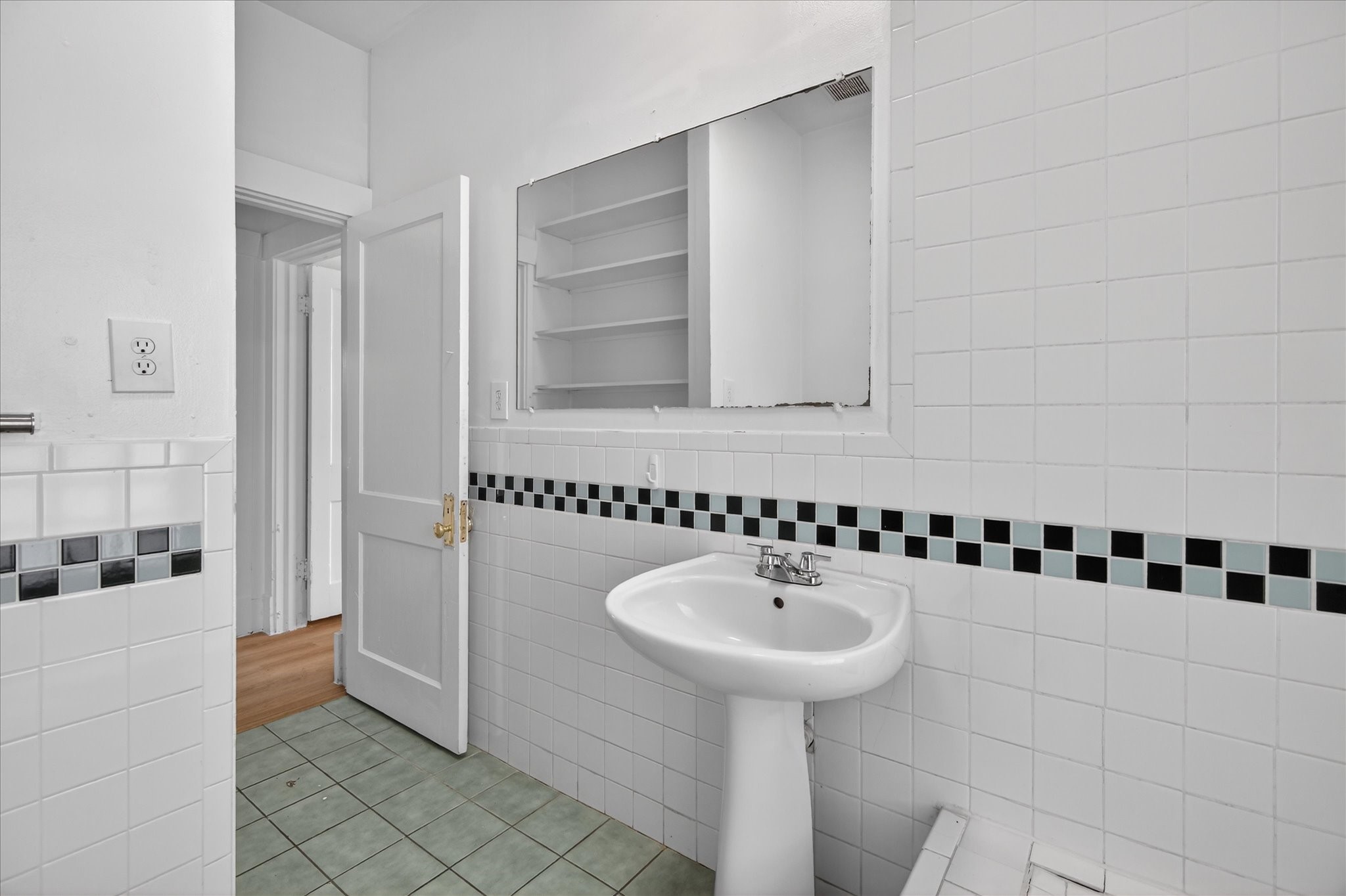 1607 Holman Street Houston, TX 77004 - Photo 22 of 24 a bathroom with a sink and a mirror