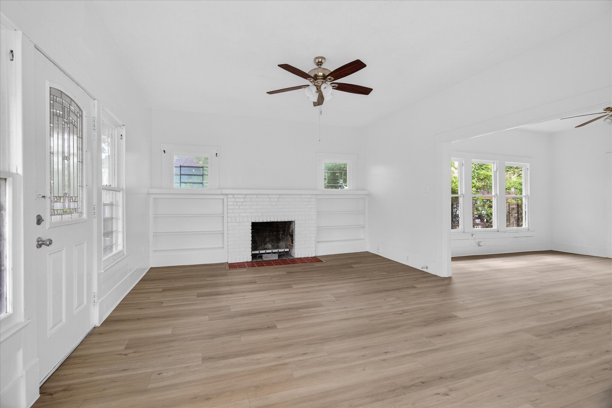 1607 Holman Street Houston, TX 77004 - Photo 3 of 24 a view of empty room with wooden floor and fan