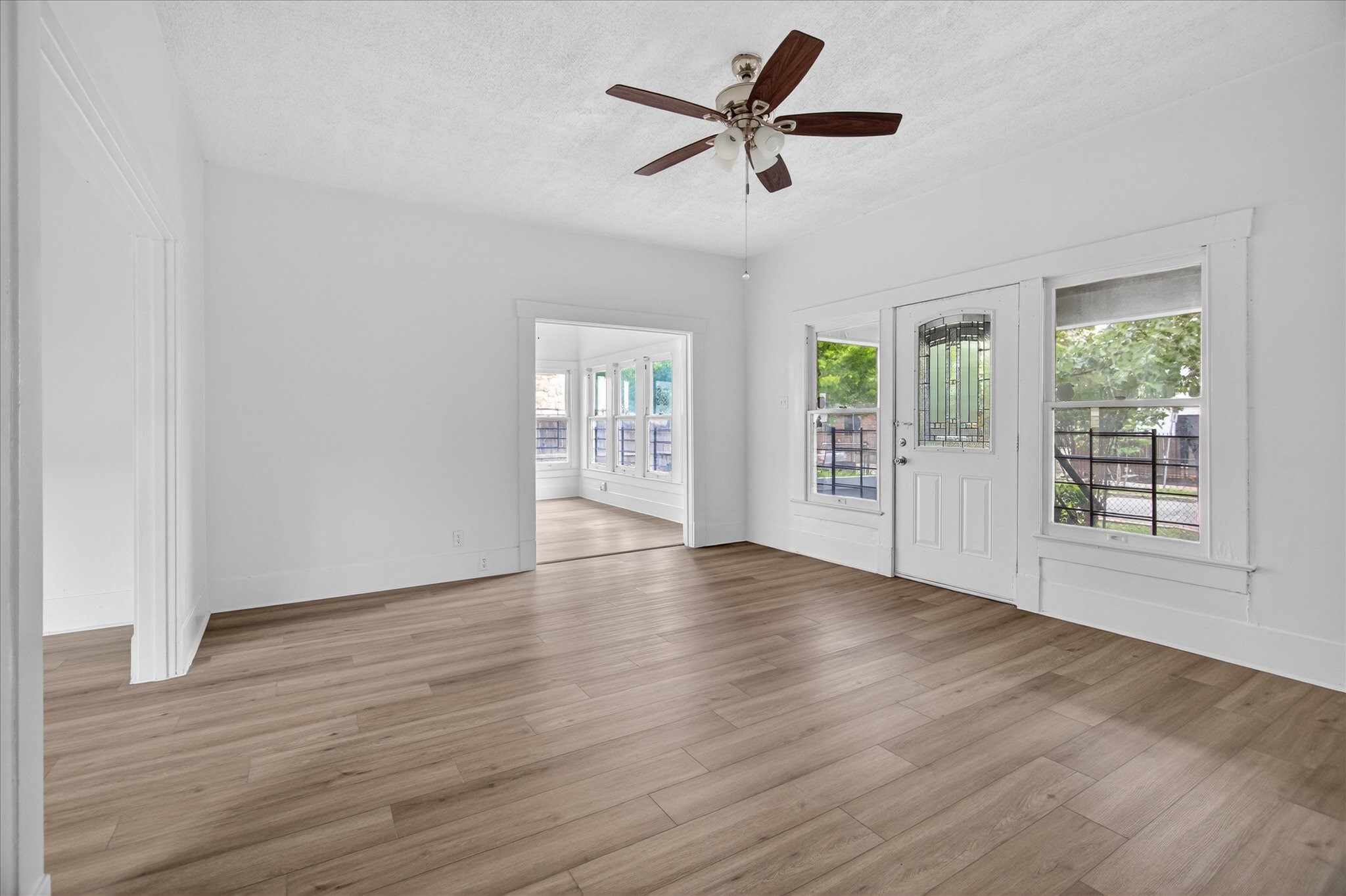1607 Holman Street Houston, TX 77004 - Photo 5 of 24 an empty room with wooden floor and windows