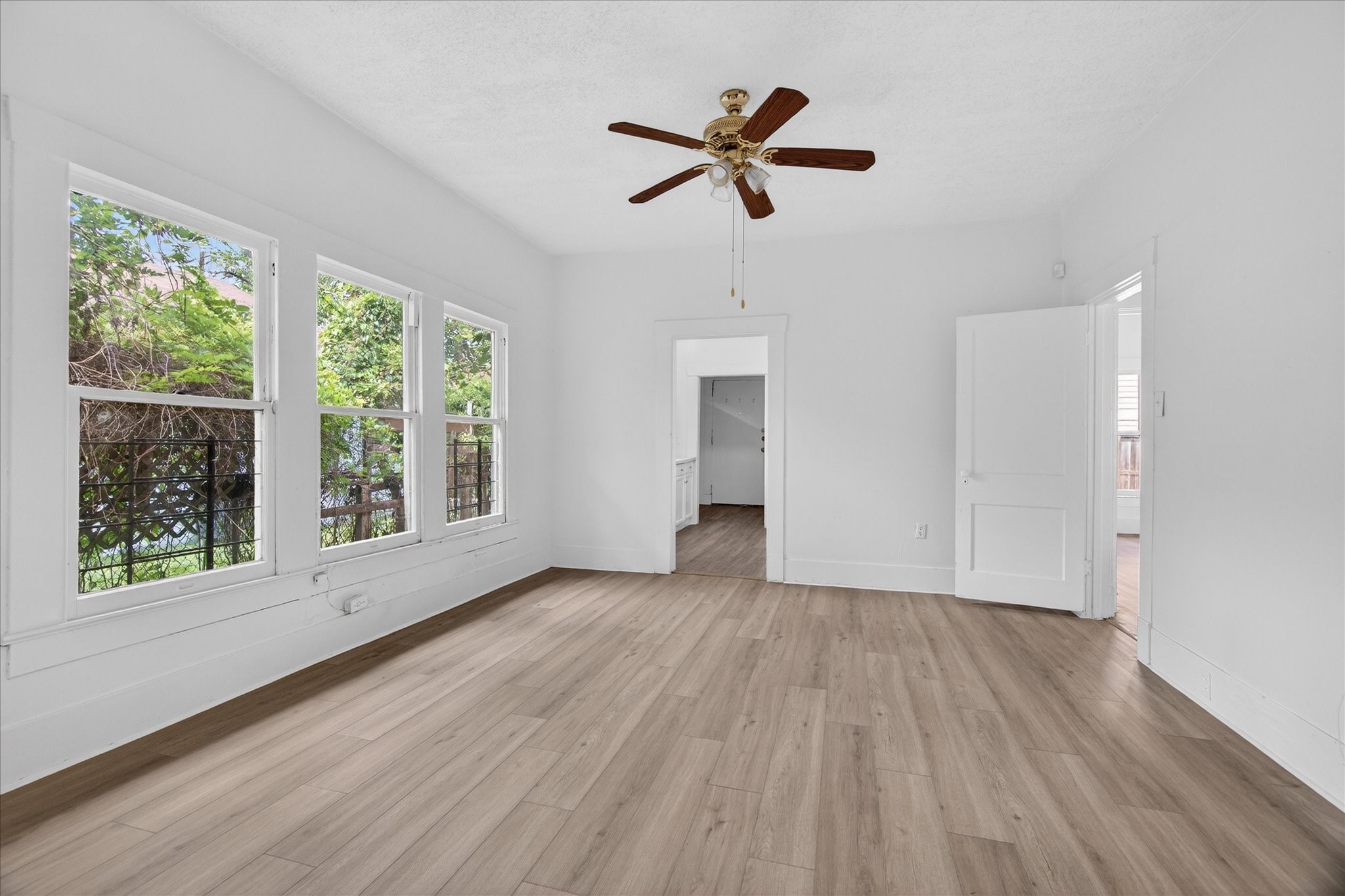 1607 Holman Street Houston, TX 77004 - Photo 7 of 24 a view of empty room with wooden floor and fan