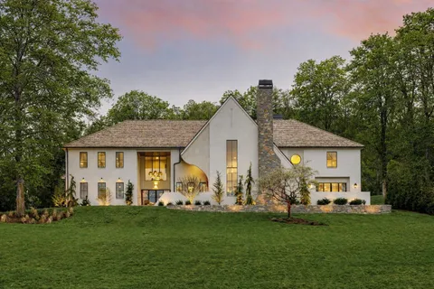 a front view of house with yard and green space