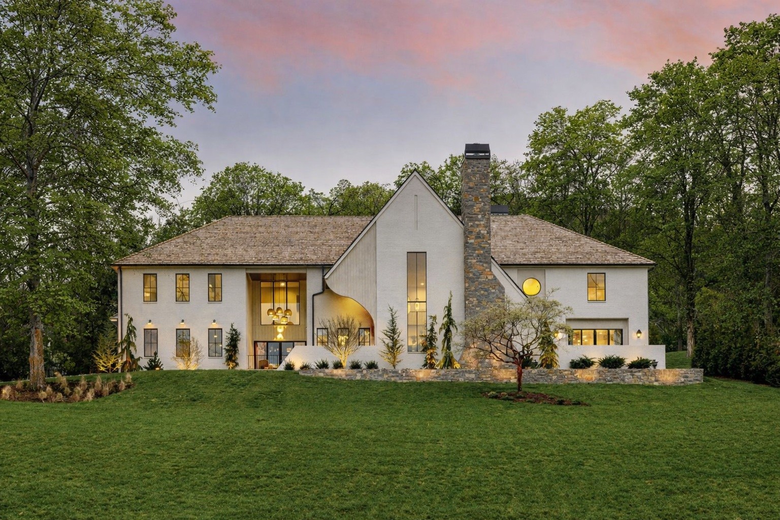 a front view of house with yard and green space