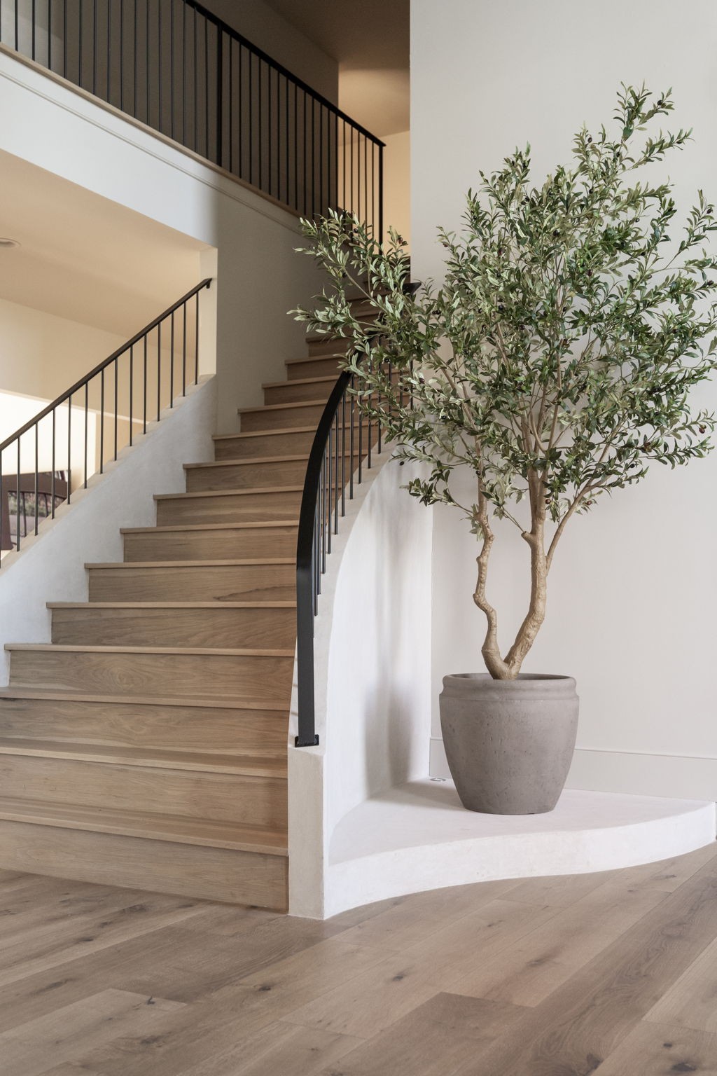 1049 Overton Lea Road Nashville, TN 37220 - Photo 36 of 53 a picture of staircase with wooden floor and a potted plant
