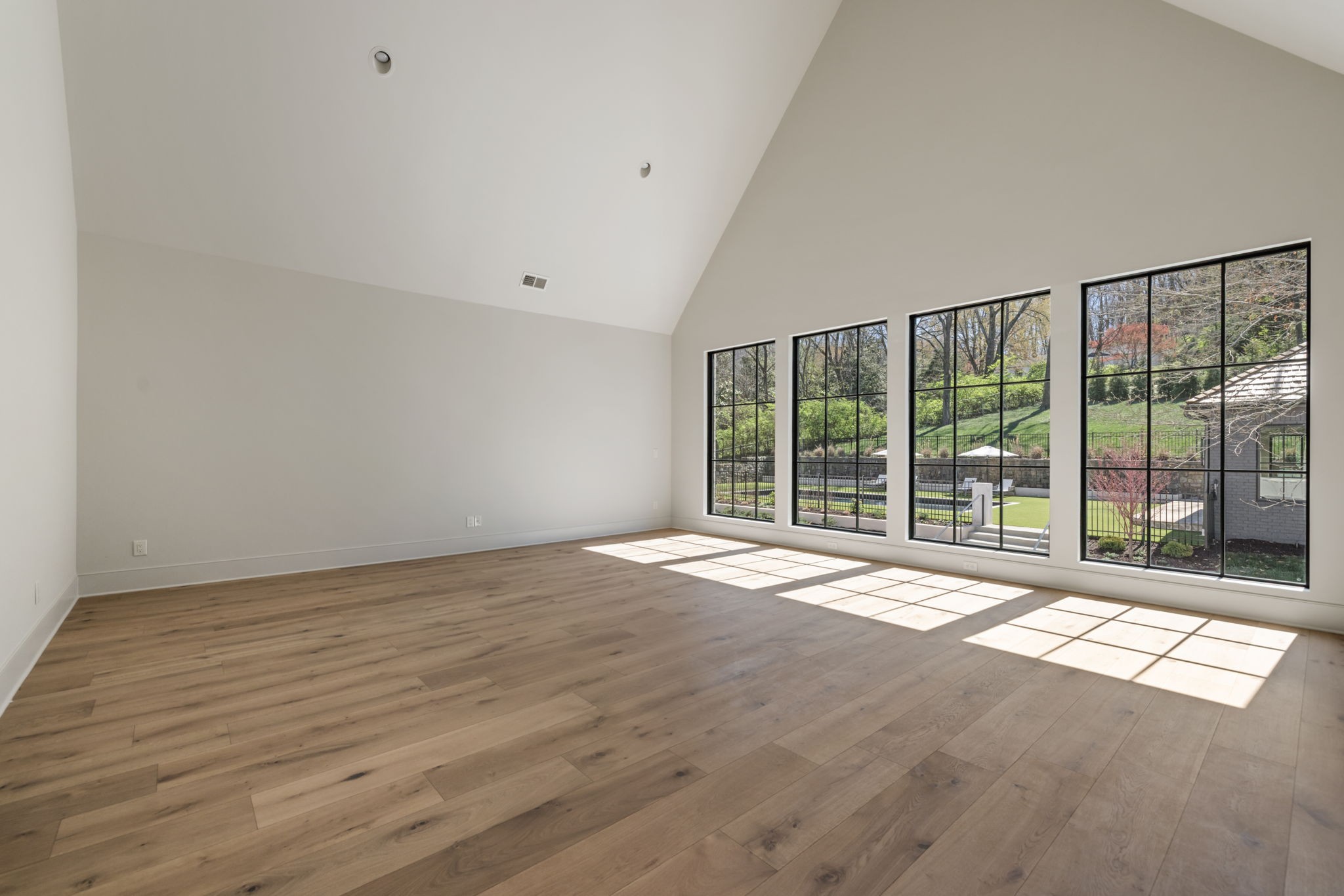 1049 Overton Lea Road Nashville, TN 37220 - Photo 38 of 53 a view of an empty room with wooden floor and a window