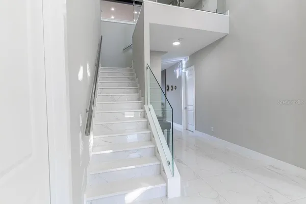a bedroom with a bed lamp and a window
