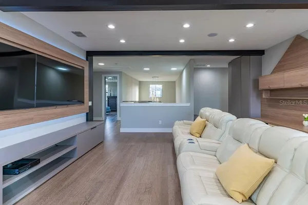 a bedroom with a bed and a flat tv screen on wall