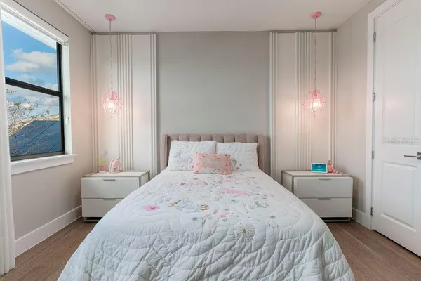 a bedroom with a bed and a flat screen tv