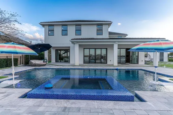 a view of a house with backyard and sitting area