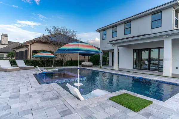 a kitchen with stainless steel appliances kitchen island granite countertop a table chairs sink and cabinets