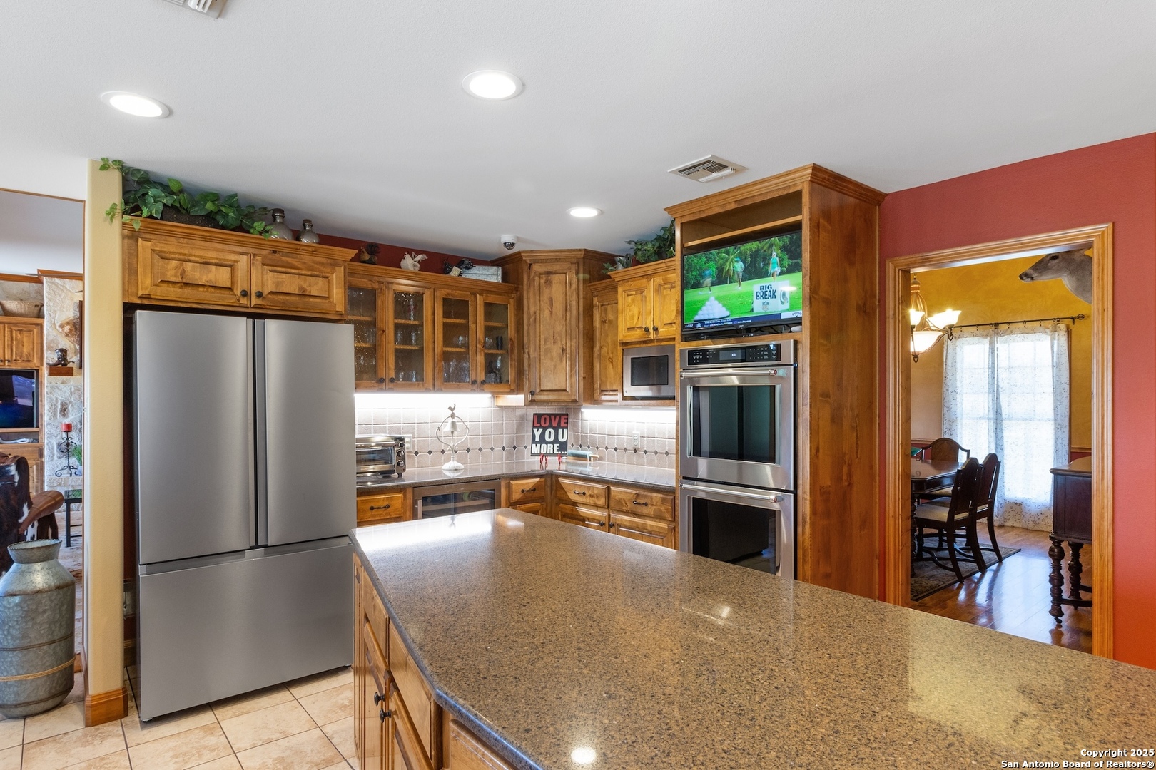 647 Funf Kinder Road Fredericksburg, TX 78624 - Photo 37 of 100 a kitchen with stainless steel appliances granite countertop a refrigerator and a stove