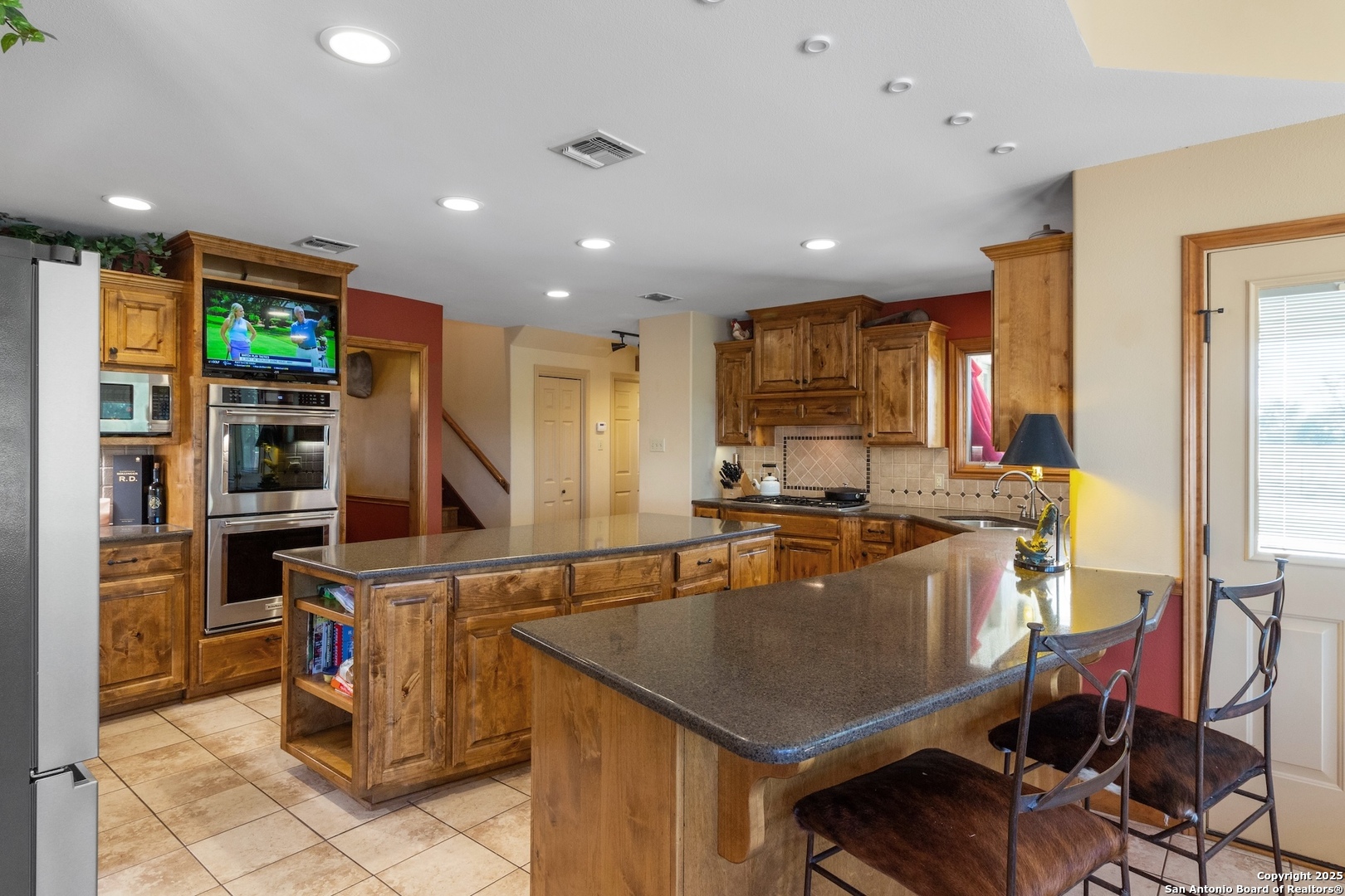647 Funf Kinder Road Fredericksburg, TX 78624 - Photo 39 of 100 a kitchen with stainless steel appliances granite countertop a sink counter space and cabinets