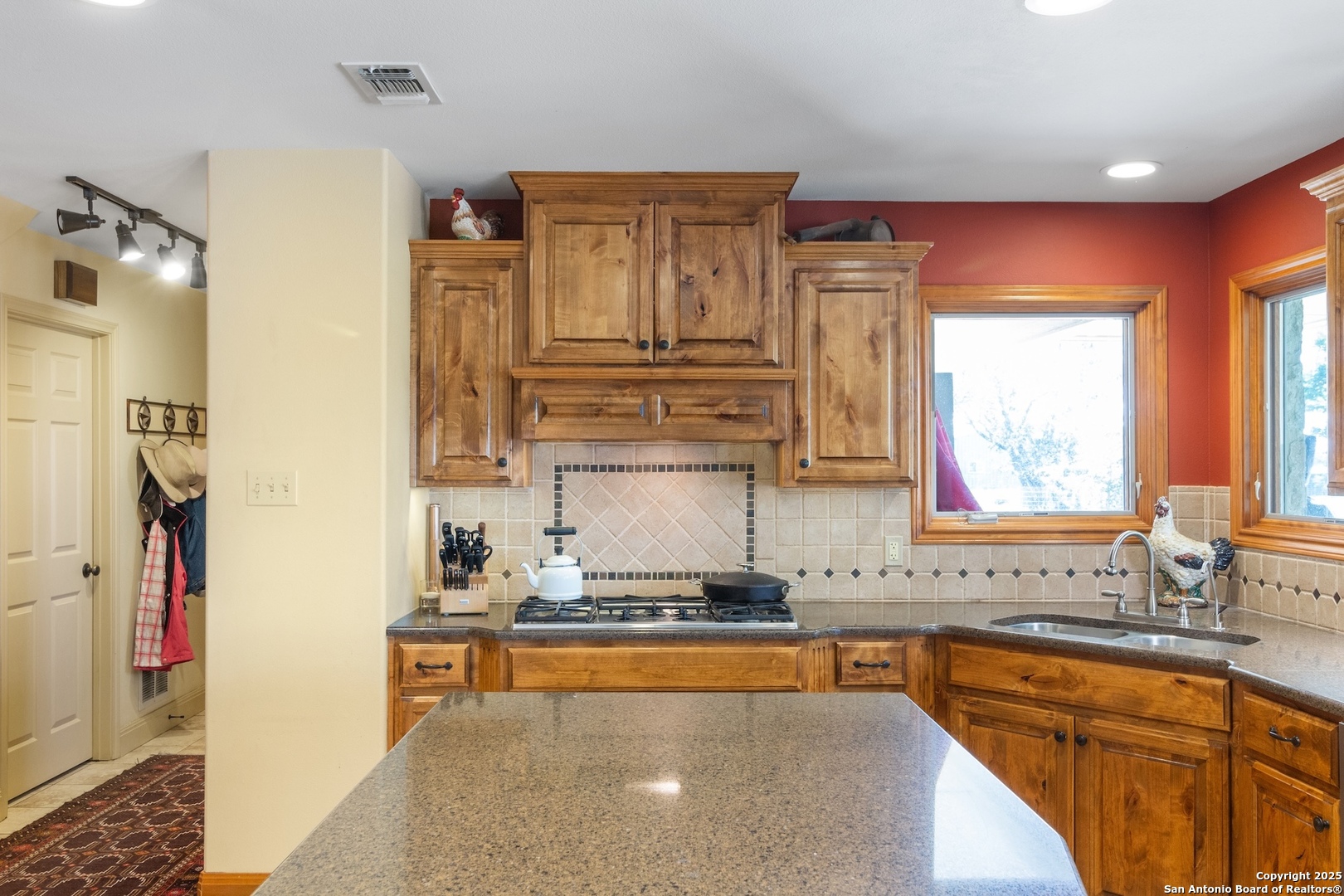 647 Funf Kinder Road Fredericksburg, TX 78624 - Photo 43 of 100 a kitchen with stainless steel appliances granite countertop a sink stove and cabinets