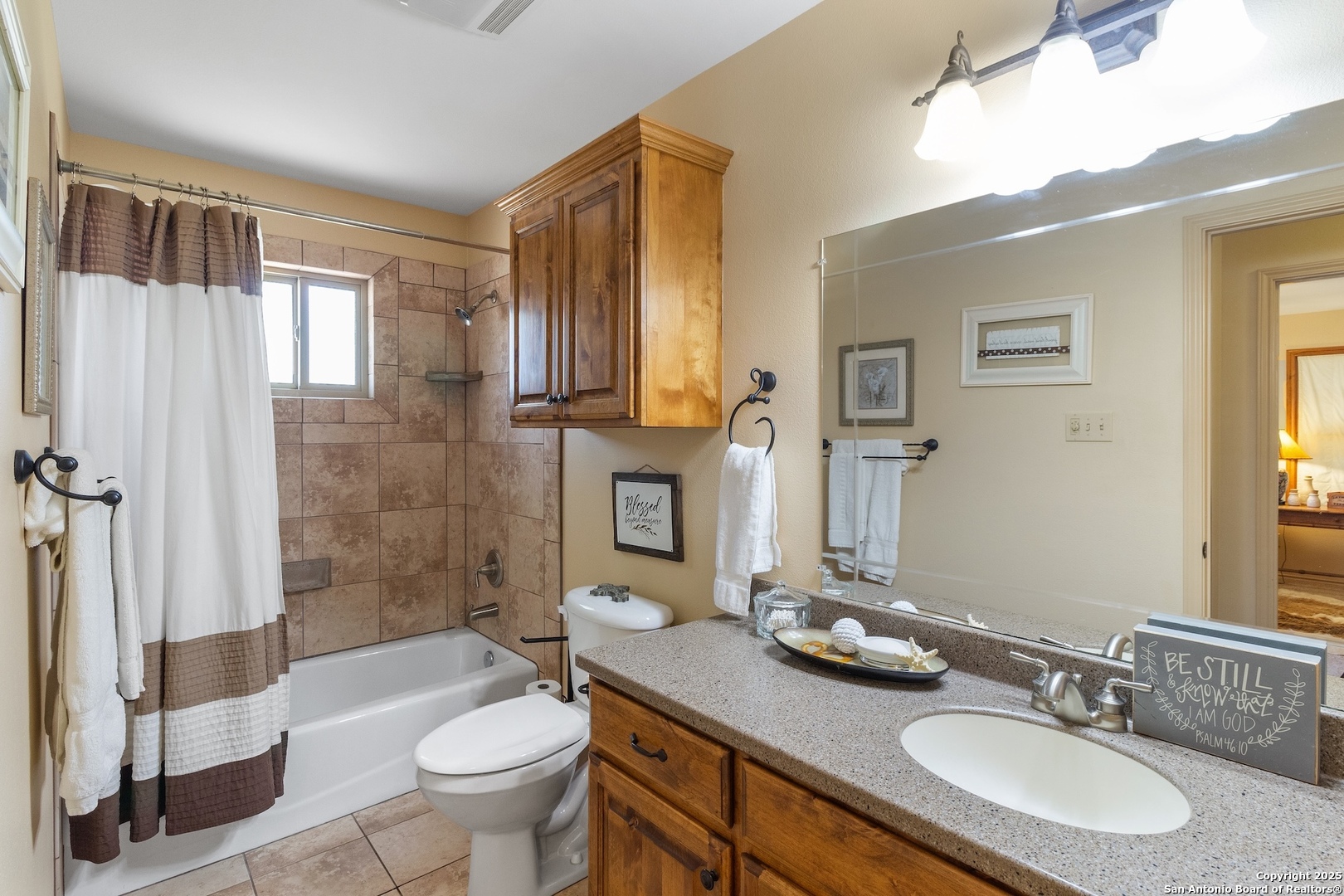 647 Funf Kinder Road Fredericksburg, TX 78624 - Photo 62 of 100 a bathroom with a granite countertop sink toilet a mirror and shower