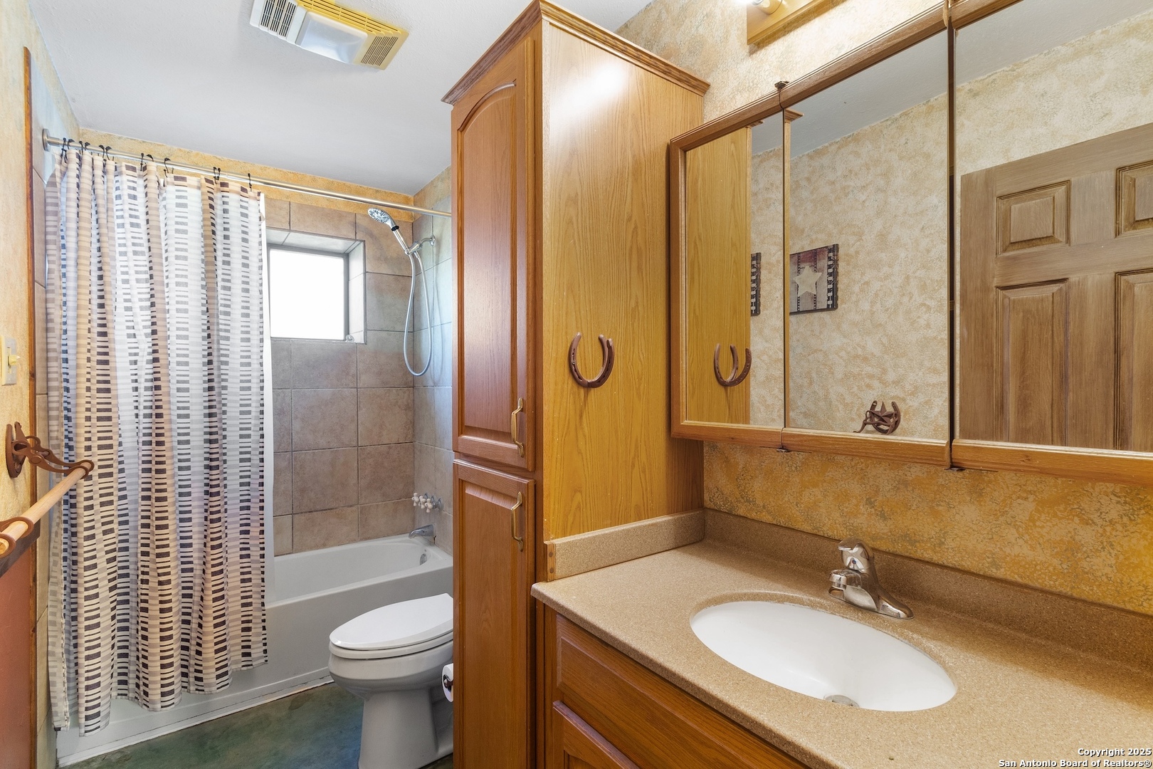 647 Funf Kinder Road Fredericksburg, TX 78624 - Photo 85 of 100 a bathroom with a sink toilet a mirror and shower