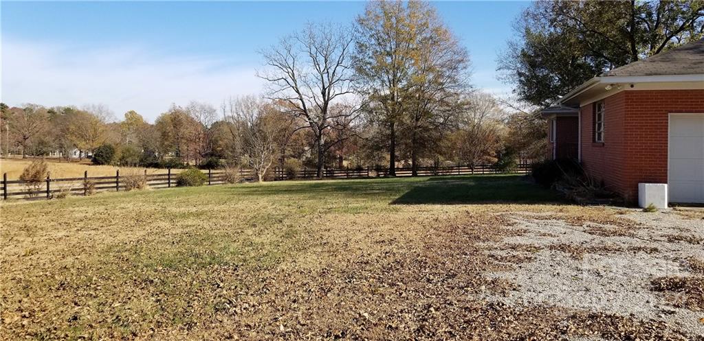 6901 Medlin Road Monroe, NC 28112 - Photo 14 of 23 a view of outdoor space with deck and trees
