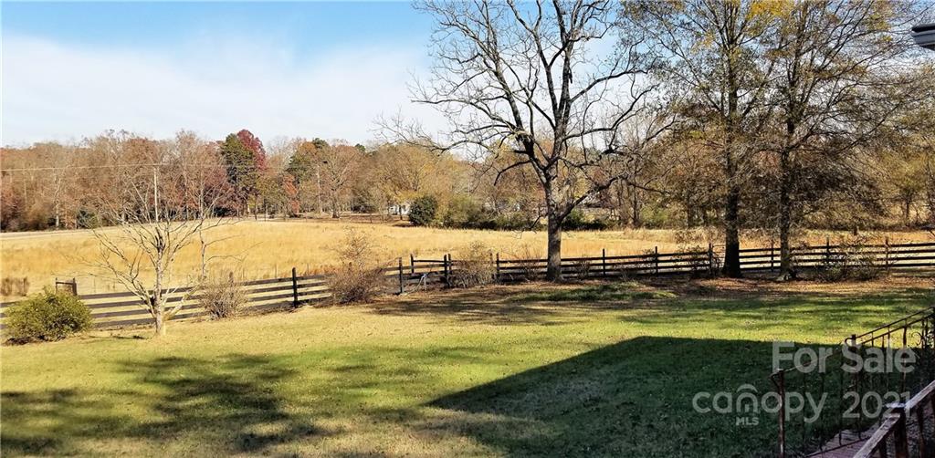 6901 Medlin Road Monroe, NC 28112 - Photo 5 of 23 a view of yard with swimming pool and trees