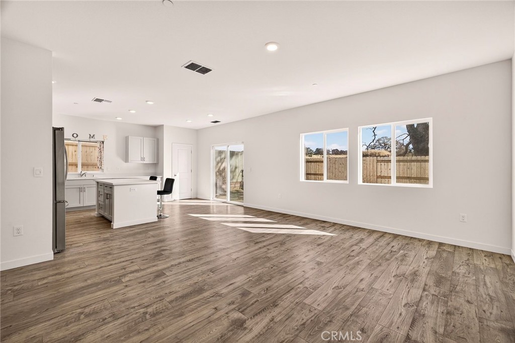 1147 Lentil Way Chico, CA 95928 - Photo 23 of 72 a view of an empty room with a window and wooden floor