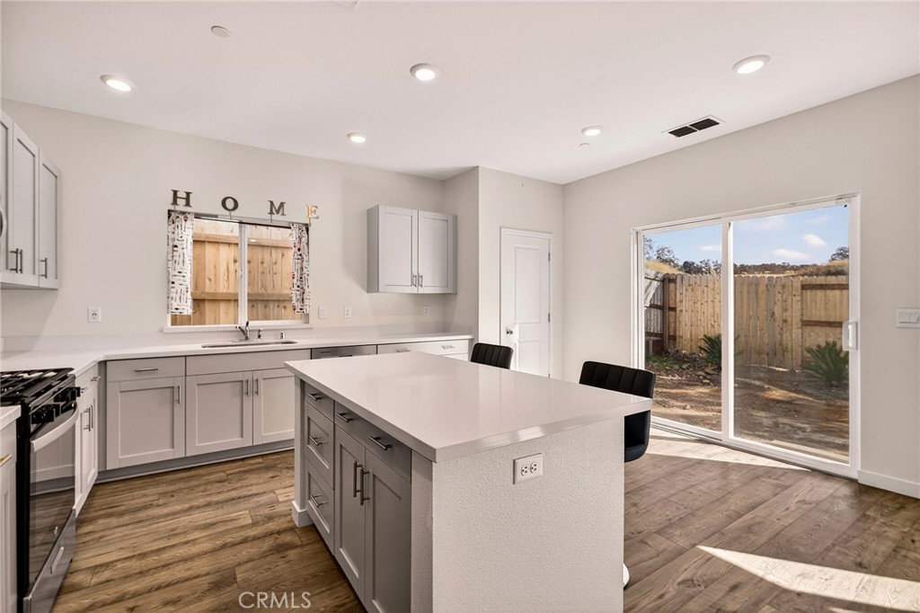1147 Lentil Way Chico, CA 95928 - Photo 27 of 72 a kitchen with a sink stove and wooden cabinets