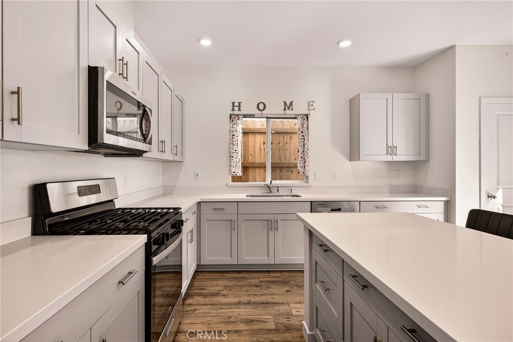 1147 Lentil Way Chico, CA 95928 - Photo 28 of 72 a kitchen with stainless steel appliances granite countertop a sink stove and cabinets