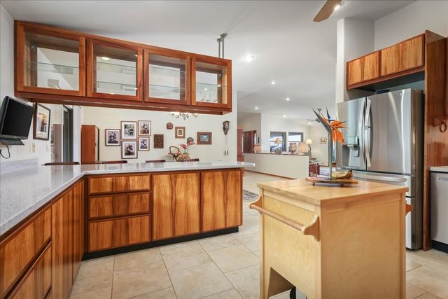 a kitchen with stainless steel appliances granite countertop a refrigerator and a stove