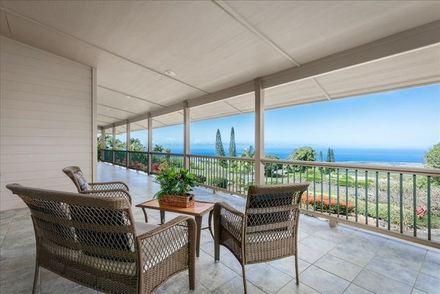 a dining room with furniture and garden view