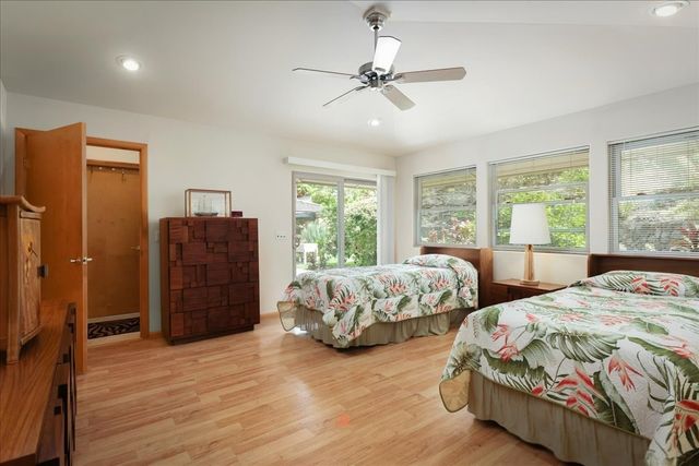 a bedroom with two beds and a dresser