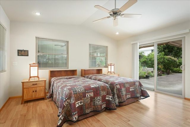 a bedroom with a bed and large window