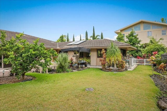 a view of a house with a yard and sitting area