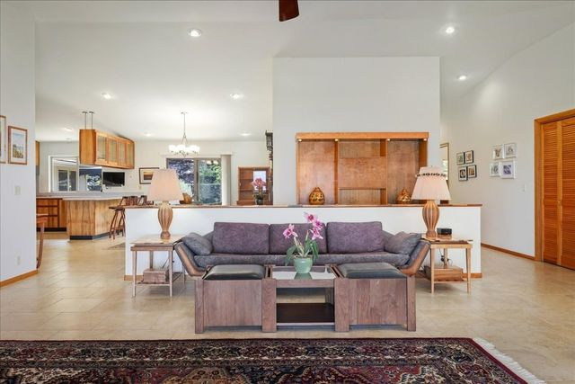 a living room with furniture and a kitchen area