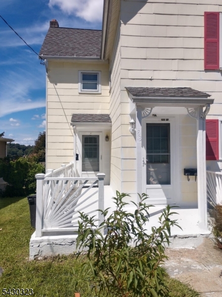 83 Allen Street, Unit 1 Netcong, NJ 07857 - Photo 2 of 16 a front view of a house with a bench